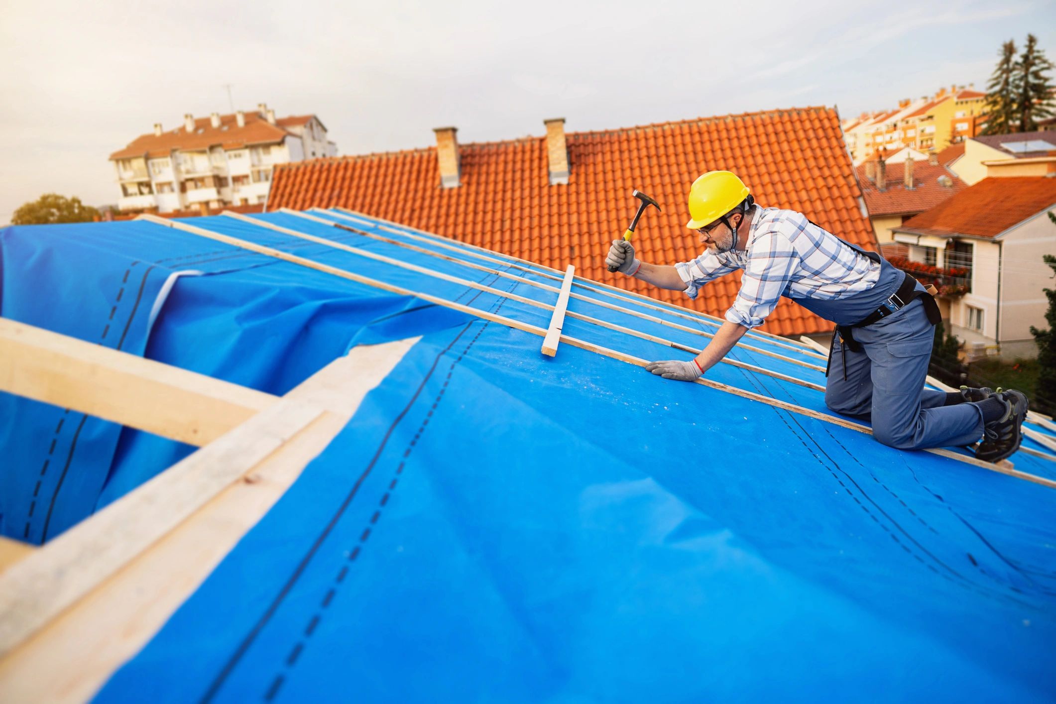 Roofer installing protective roof covering
