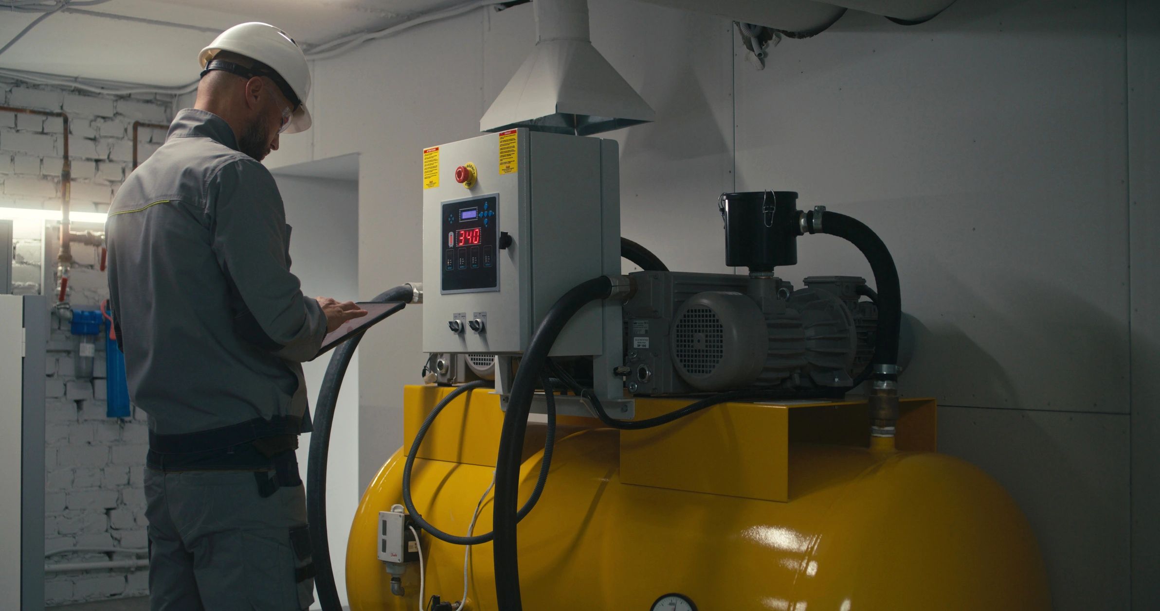 Technician monitoring restoration equipment with a tablet
