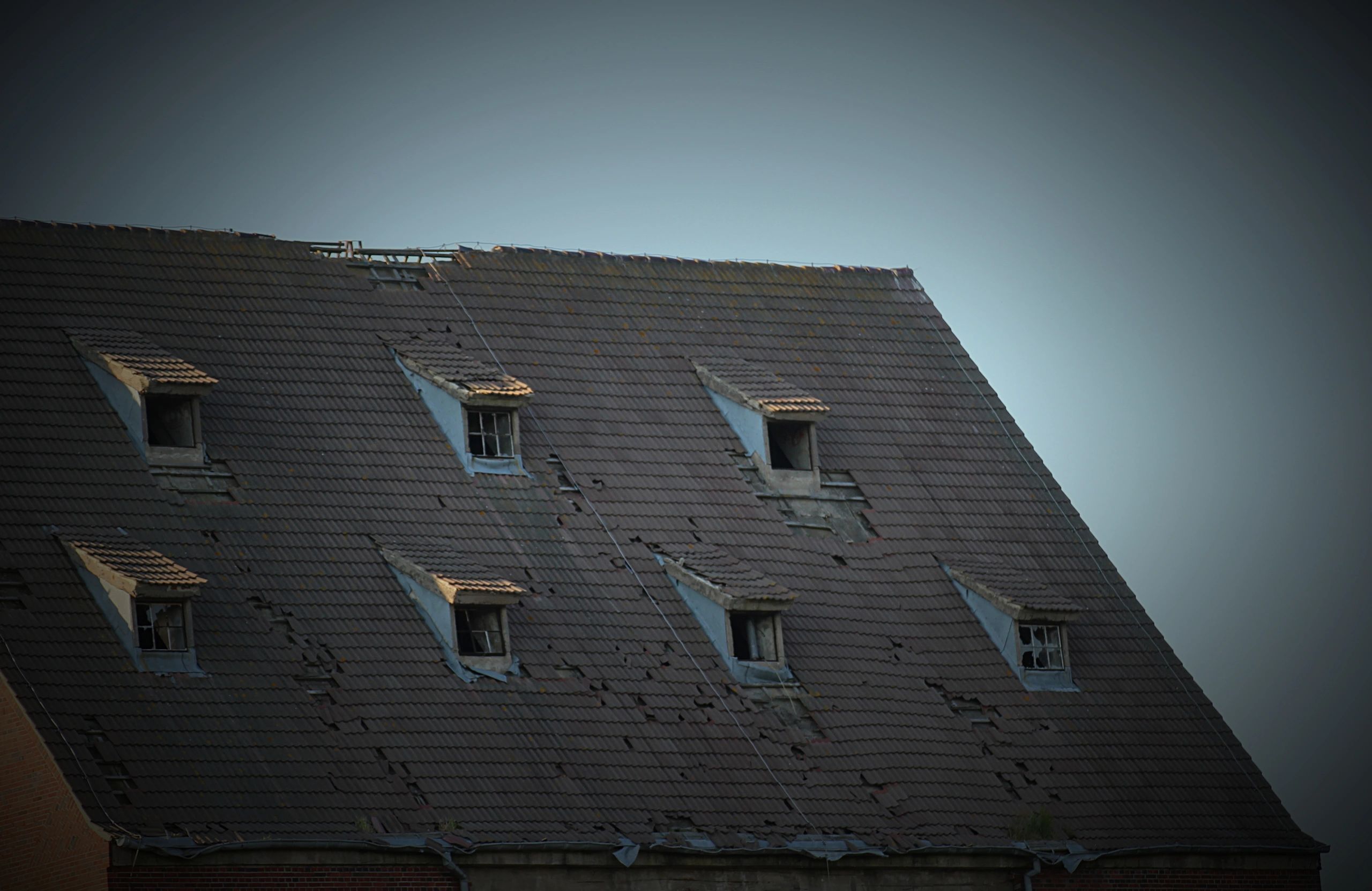 Storm-damaged roof on a Scottsdale home awaiting emergency repair